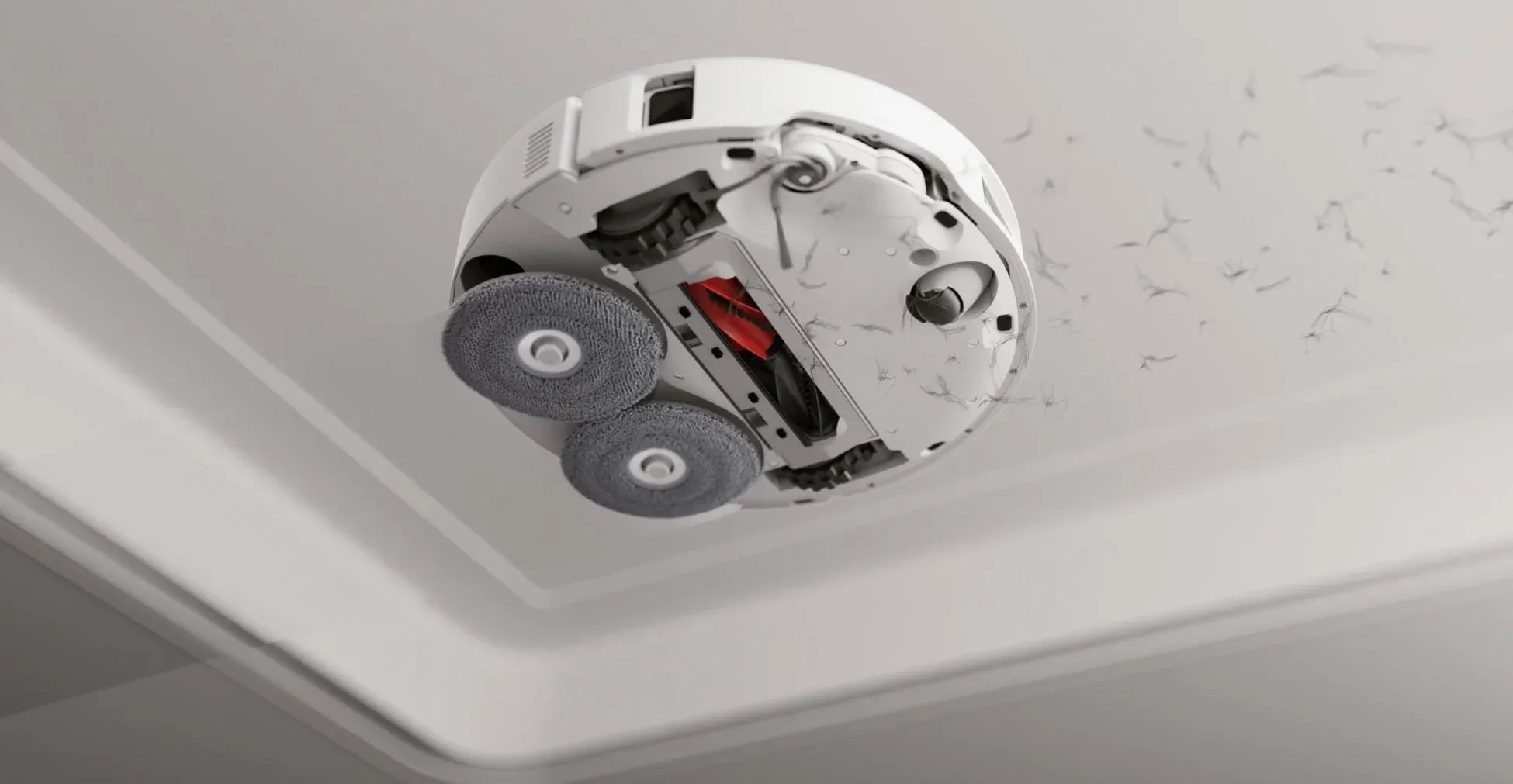 白いロボット掃除機が宙に浮き、その裏側から見た様子が描かれている。周囲には舞い上がるホコリやゴミがあり、強力な清掃機能をアピールしている。