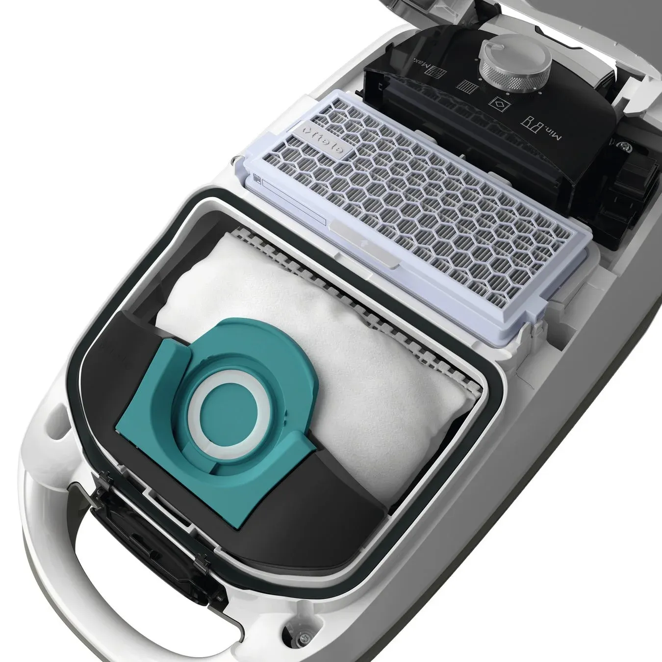 掃除機の内部構造が写っており、白いダストバッグとハニカム状のフィルターが確認できます。Miele製掃除機の部品やメンテナンスの様子を示しています。